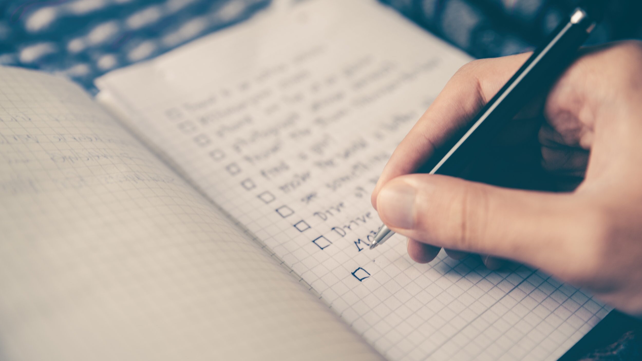 Close up of a hand checking off items on a checklist