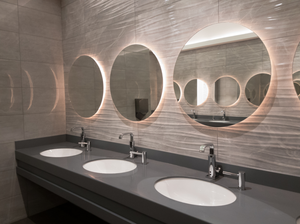 Modern workplace washroom with clean sinks and mirrors showing proper hygiene standards.